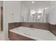 Bathroom featuring a white soaking tub with tile surround and chrome fixtures at 2090 S Gray Dr, Lakewood, CO 80227