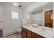 Bathroom with a double sink vanity, large mirror, and natural light from the window at 2090 S Gray Dr, Lakewood, CO 80227