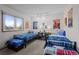 Bedroom featuring two beds, large window, and colorful decor at 2090 S Gray Dr, Lakewood, CO 80227