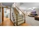 Welcoming entryway featuring hardwood floors and carpeted stairs leading to the upper level at 2090 S Gray Dr, Lakewood, CO 80227
