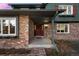 Charming front porch with brick accents and covered entryway at 2090 S Gray Dr, Lakewood, CO 80227