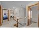 Upstairs hallway with carpet, wood trim, and multiple bedroom entrances at 2090 S Gray Dr, Lakewood, CO 80227