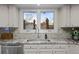 Kitchen featuring white cabinets, granite countertops, stainless steel appliances and modern faucet at 2090 S Gray Dr, Lakewood, CO 80227