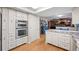 Modern kitchen featuring built in oven and microwave, granite countertops, stainless steel appliances, and wood flooring at 2090 S Gray Dr, Lakewood, CO 80227