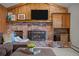 Close up of a brick fireplace with wooden beam mantle in cozy living room at 2090 S Gray Dr, Lakewood, CO 80227