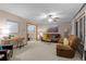 Spacious living room with a ceiling fan, comfortable seating, and a view into the dining area at 2090 S Gray Dr, Lakewood, CO 80227