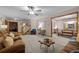 Inviting living room featuring a ceiling fan, plush carpet, and an open layout into the dining area at 2090 S Gray Dr, Lakewood, CO 80227