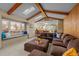 Bright living room with beamed ceilings, skylights, a large window seat and a comfortable, oversized sectional couch at 2090 S Gray Dr, Lakewood, CO 80227