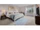 Main bedroom with a large window, a cozy bed, and a blue rug at 2090 S Gray Dr, Lakewood, CO 80227