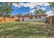 This backyard is fenced and features mature trees and a well maintained yard at 14317 Olmsted Dr, Denver, CO 80239