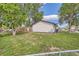 Backyard featuring mature trees with grass and a home with light-colored paint at 14317 Olmsted Dr, Denver, CO 80239