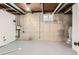 Unfinished basement with exposed ceiling, concrete walls, and a single window at 14317 Olmsted Dr, Denver, CO 80239