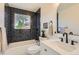 Beautiful bathroom with dark subway tile, white vanity, and modern fixtures at 14317 Olmsted Dr, Denver, CO 80239