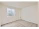 This cozy bedroom features neutral carpet, white walls, and a window for natural light at 14317 Olmsted Dr, Denver, CO 80239