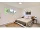 Bright bedroom featuring a large window and a comfortable bed with neutral decor at 14317 Olmsted Dr, Denver, CO 80239