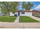 Newly renovated home with mature shade trees and a lush front lawn at 14317 Olmsted Dr, Denver, CO 80239