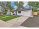 Cozy home with fresh exterior paint, driveway, and mature trees at 14317 Olmsted Dr, Denver, CO 80239