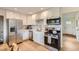 Bright kitchen features stainless steel appliances, white cabinets, and subway tile backsplash at 14317 Olmsted Dr, Denver, CO 80239