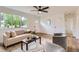 Bright and airy living room featuring wood floors and a large window at 14317 Olmsted Dr, Denver, CO 80239