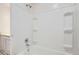 Clean bathroom featuring a shower-tub combo and built-in shelving at 12148 E Kepner Pl, Aurora, CO 80012
