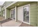 Exterior photo of a townhouse entrance with a storm door and picture window at 12148 E Kepner Pl, Aurora, CO 80012