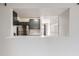 Open kitchen layout with stainless steel refrigerator and gray cabinets viewed from adjacent room at 12148 E Kepner Pl, Aurora, CO 80012