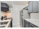 Cozy kitchen featuring stainless steel appliances, sleek gray cabinets and marble countertops at 12148 E Kepner Pl, Aurora, CO 80012