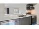 Modern kitchen with stainless steel appliances and a breakfast bar at 12148 E Kepner Pl, Aurora, CO 80012