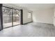 A bright living room features wood floors and a sliding glass door to the backyard at 12148 E Kepner Pl, Aurora, CO 80012