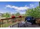 Back deck featuring a grill, seating, and views of the backyard landscaping at 16671 E Prairie Goat Ave, Parker, CO 80134