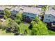 Aerial view of a backyard with mature trees, lush lawn, wooden deck, and outdoor seating area at 16671 E Prairie Goat Ave, Parker, CO 80134