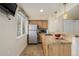 Basement bar area with modern appliances, breakfast bar, and recessed lighting at 16671 E Prairie Goat Ave, Parker, CO 80134
