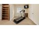Basement workout area with a treadmill, built-in shelving, and natural light at 16671 E Prairie Goat Ave, Parker, CO 80134