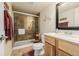 Bathroom features a glass-enclosed shower, wood vanity, and modern fixtures at 16671 E Prairie Goat Ave, Parker, CO 80134