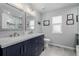 Modern bathroom with double vanity, marble countertops, and custom tile work at 16671 E Prairie Goat Ave, Parker, CO 80134