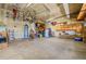 Spacious garage featuring ample storage cabinets, work bench, and ceiling-mounted bicycle racks at 16671 E Prairie Goat Ave, Parker, CO 80134