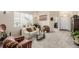 Cozy living room with plush carpeting, comfortable seating, and abundant natural light from the window at 16671 E Prairie Goat Ave, Parker, CO 80134