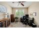 Functional office space with a ceiling fan, large window, and ample desk space for productivity at 16671 E Prairie Goat Ave, Parker, CO 80134