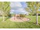Well-maintained community playground with shelter, swings, playset, and wood chip ground cover at 16671 E Prairie Goat Ave, Parker, CO 80134