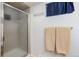 Bathroom featuring tiled shower with glass doors and neutral-toned towels at 16 N Pennsylvania St, Denver, CO 80203