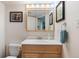 Bright bathroom with mirrored medicine cabinet, towel bar, and light wood vanity at 16 N Pennsylvania St, Denver, CO 80203