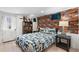 Bedroom features accent wall, white door, and plaid bedspread at 16 N Pennsylvania St, Denver, CO 80203