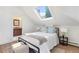 Bedroom featuring skylight, adjacent bathroom, and comfortable decor at 16 N Pennsylvania St, Denver, CO 80203