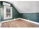 Empty bedroom with painted walls, wood-look floors, and window view of exterior at 16 N Pennsylvania St, Denver, CO 80203