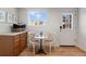 Charming breakfast nook featuring a small table with two chairs, a storage cabinet, and a bright window at 16 N Pennsylvania St, Denver, CO 80203