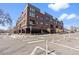 Modern brick building exterior with large windows and stylish balconies, located on a city street at 16 N Pennsylvania St, Denver, CO 80203