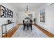 Elegant dining room with hardwood floors, stylish lighting, and a large window for ample natural light at 16 N Pennsylvania St, Denver, CO 80203