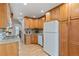 Functional kitchen with natural wood cabinets, granite countertops, and modern appliances, offering a cozy cooking space at 16 N Pennsylvania St, Denver, CO 80203