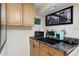 Kitchenette includes appliances, cabinets, and granite countertop at 16 N Pennsylvania St, Denver, CO 80203
