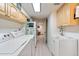 Functional laundry room features a washer, dryer, sink, and overhead cabinets at 16 N Pennsylvania St, Denver, CO 80203